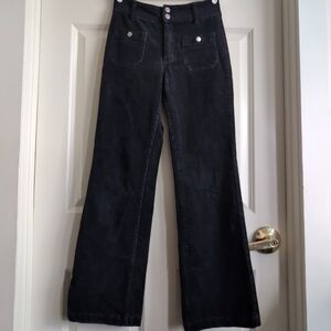 Indigo high-rise corduroy flares with 70s-style front buttons and sailor pockets